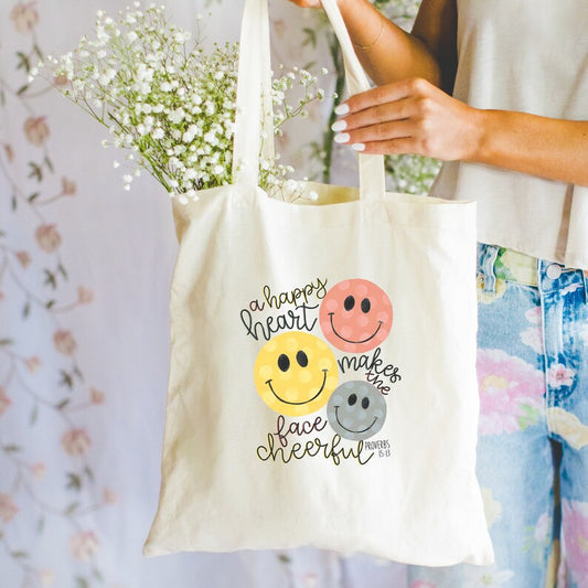 A happy heart makes the face cheerful tote bag